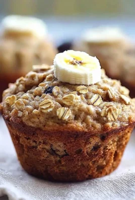 Freshly baked banana oatmeal muffins on a wooden table