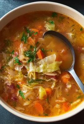 Bowl of delicious homemade cabbage soup garnished with herbs