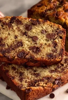 Delicious slice of chocolate chip banana bread on a wooden table