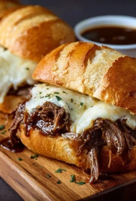 Delicious Crockpot French Dip Sandwiches served with au jus for dipping
