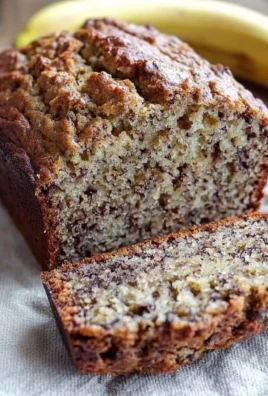 Slice of easy and healthy banana bread on a wooden cutting board