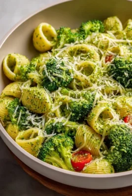 A plate of easy healthy broccoli pasta garnished with fresh herbs.
