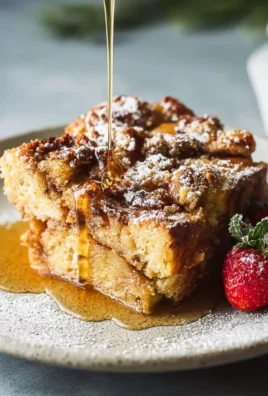 Delicious homemade French Toast Casserole topped with syrup and berries.