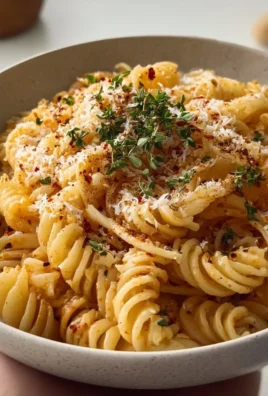 A delicious plate of Garlic Butter Pasta with herbs and grated cheese.