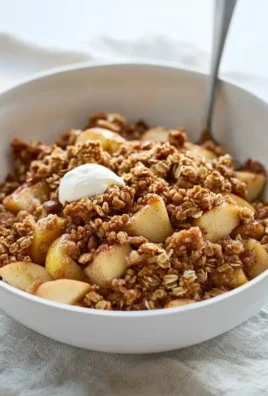 Healthy breakfast apple crumble with oats and cinnamon in a bowl