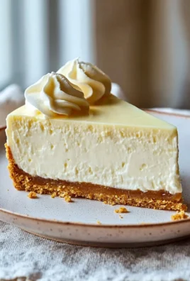 Slice of healthy cheesecake topped with fresh berries and mint leaves