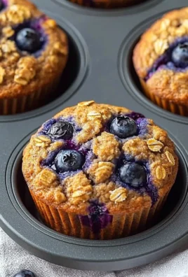 Hearty blueberry protein muffins on a wooden table, ready to enjoy.