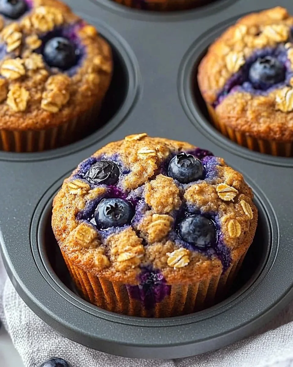 Hearty blueberry protein muffins on a wooden table, ready to enjoy.