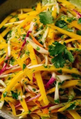 Mango Slaw with fresh mango, cabbage, and vegetables in a bowl