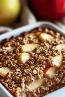 Baked oatmeal apple breakfast dish topped with fresh apples and nuts