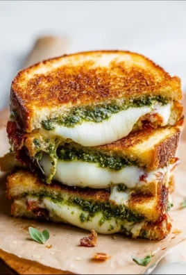 Pesto grilled cheese sandwich with melted cheese and fresh pesto
