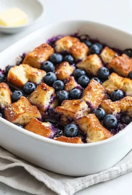 Quick blueberry French toast casserole baked until golden and topped with fresh berries.