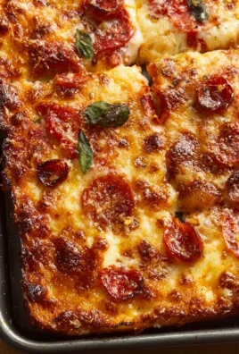 Delicious homemade sheet pan pizza topped with fresh ingredients and melted cheese.