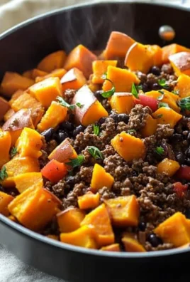 Southwestern Ground Beef Sweet Potato Skillet in a frying pan with colorful veggies