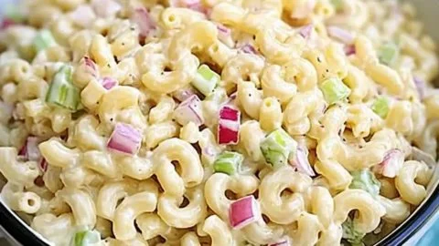 Classic Macaroni Salad in a serving bowl, featuring creamy dressing and vegetables.
