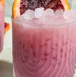 Creamy Blood Orange Margarita Mocktail served in a glass with vibrant colors.