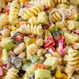 Creamy pasta salad with fresh vegetables and dressing in a bowl
