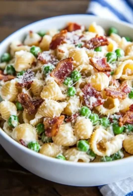 Creamy pasta salad with vegetables and dressing in a bowl