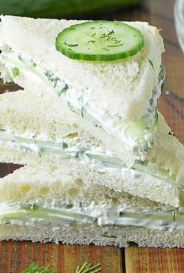 Plate of fresh cucumber sandwiches ready to be served at a tea party.