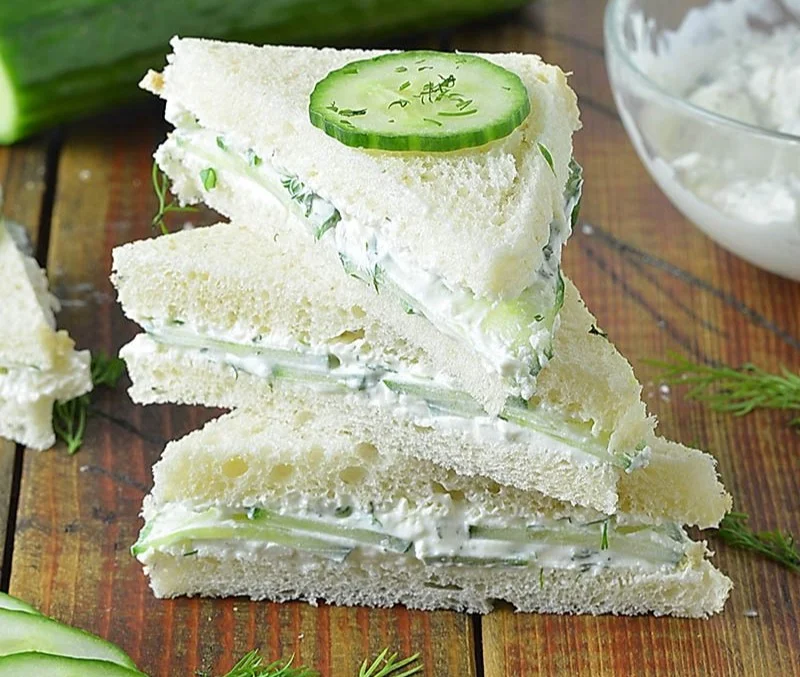 Plate of fresh cucumber sandwiches ready to be served at a tea party.
