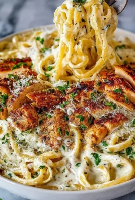 Delicious Chicken Alfredo served on a plate with garnishes.
