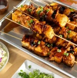 Delicious Hawaiian Chicken Kabobs on skewers with colorful peppers and pineapple.