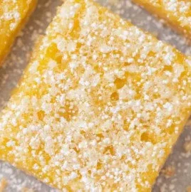 A plate of easy lemon squares with powdered sugar on top.