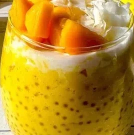 Easy Mango Sago dessert pudding served in a bowl with fresh mango slices.
