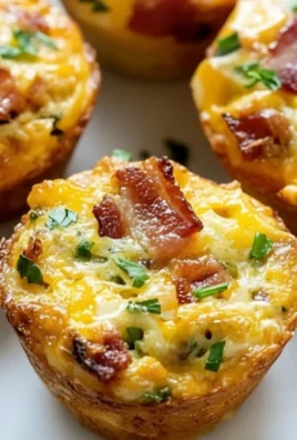 Delicious egg muffin cups baked in colorful muffin cups for a tasty breakfast.