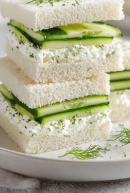 Delicious English cucumber sandwiches on a plate, perfect for tea time.