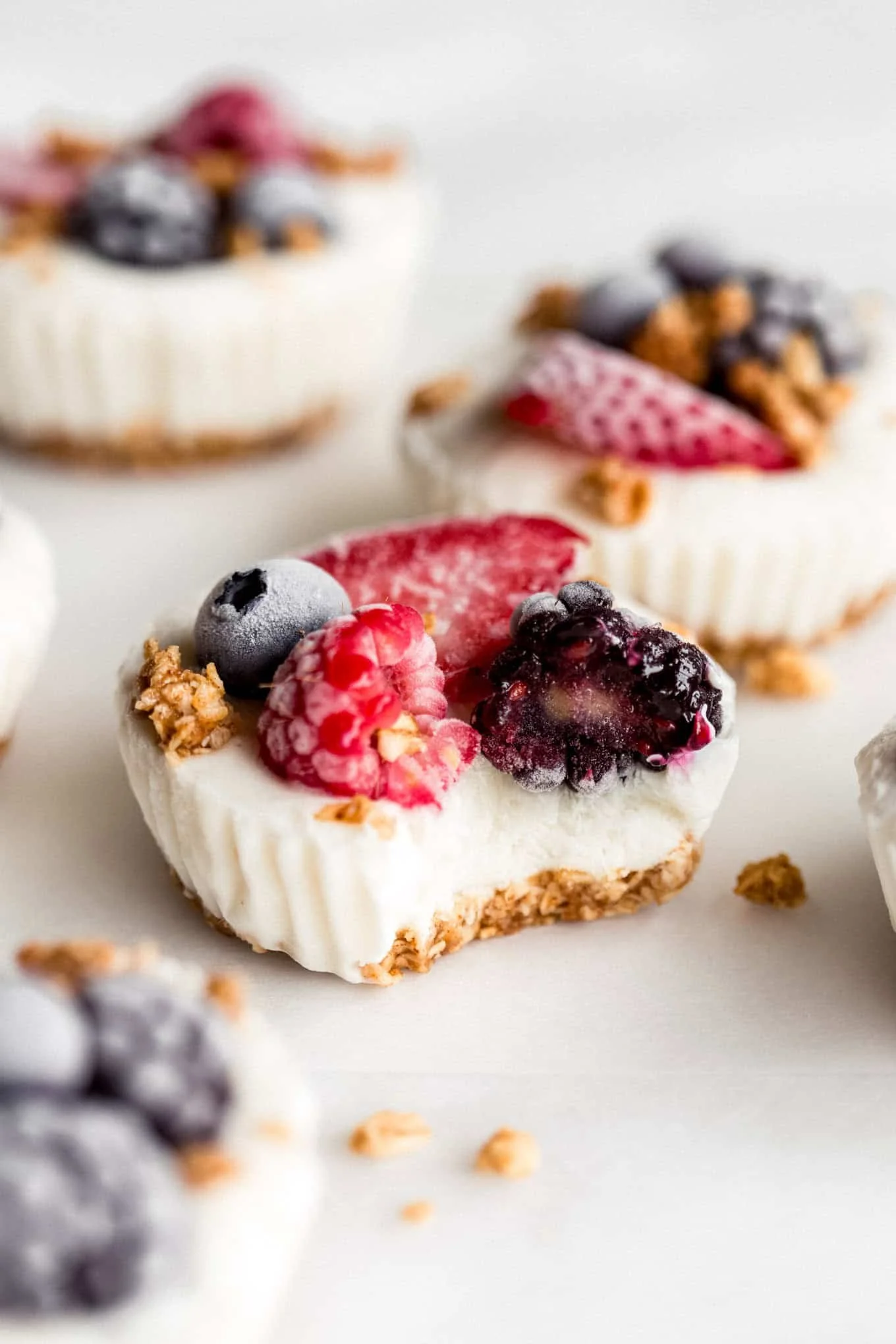 Frozen yogurt granola cups topped with fresh fruit and granola.