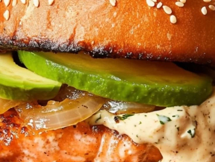 Gordon Ramsay's delicious salmon burger served with toppings and sides.