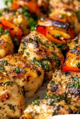 Greek marinated chicken kabobs on skewers with colorful vegetables