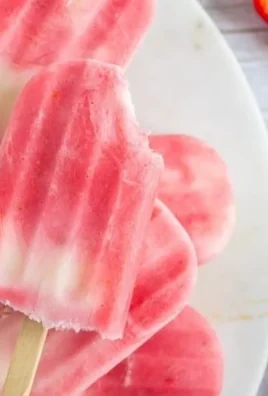 Colorful Greek Yogurt Popsicles with fresh fruit on a wooden board