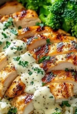 Grilled chicken and broccoli bowls topped with creamy garlic sauce
