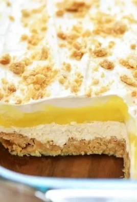 Heavenly Oreo Lemon Dessert featuring creamy lemon layers and crushed Oreo crust.