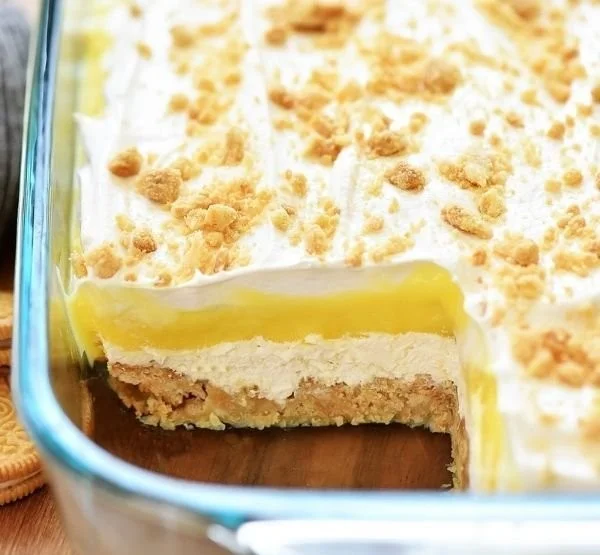 Heavenly Oreo Lemon Dessert featuring creamy lemon layers and crushed Oreo crust.