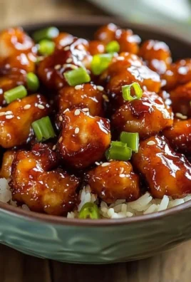 Delicious sweet chili chicken served on a plate with garnishes.