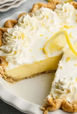 Delicious lemon cream pie topped with a dollop of whipped cream and lemon zest.