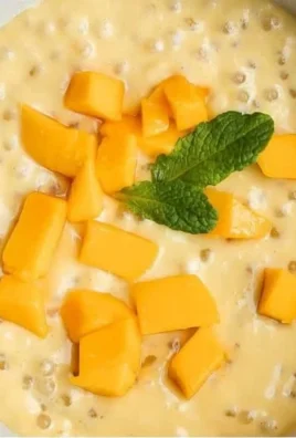 Delicious Mango Sago dessert topped with fresh mango and sago pearls