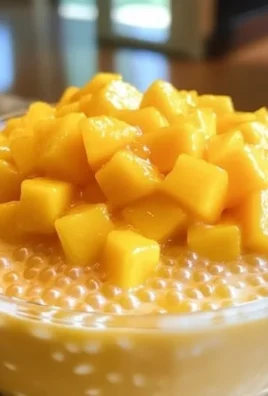 Delicious Mango Sago dessert topped with fresh mango slices and sago pearls.