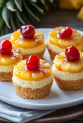 Mini Pineapple Upside Down Cheesecakes on a white plate with pineapple topping