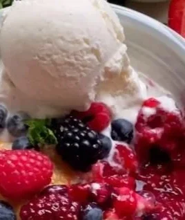 Freshly baked mixed berry cobbler with a golden crust and mixed berries