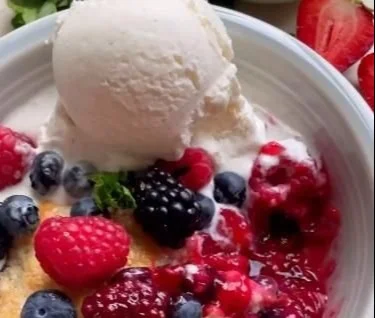Freshly baked mixed berry cobbler with a golden crust and mixed berries