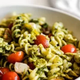 Delicious pesto pasta salad with fresh vegetables in a bowl