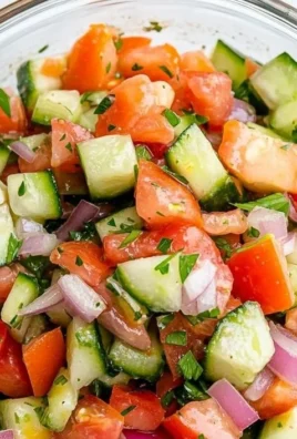 Bowl of refreshing Italian Cucumber Salad with tomatoes and herbs