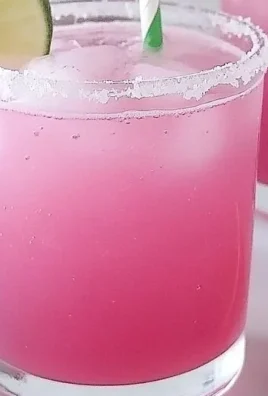 Sweet prickly pear margarita mocktail served in a glass with lime garnish