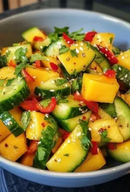 Bowl of Thai Mango Cucumber Salad with fresh ingredients