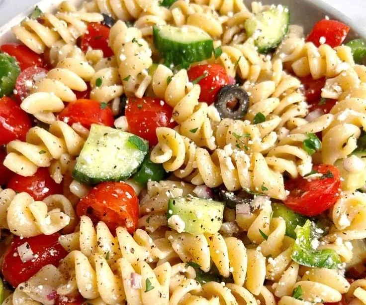 Delicious pasta salad with colorful vegetables and Italian dressing