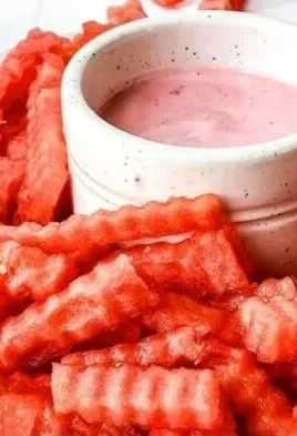 Watermelon fries served with strawberry yogurt dip in a colorful presentation